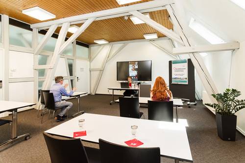 Quelle: Erzbischöfliches Seelsorgeamt Freiburg - Bildungshäuser und Familienferienstätten Ansicht einer hybriden Konferenz mit Personen im Bildungshaus St. Bernhard